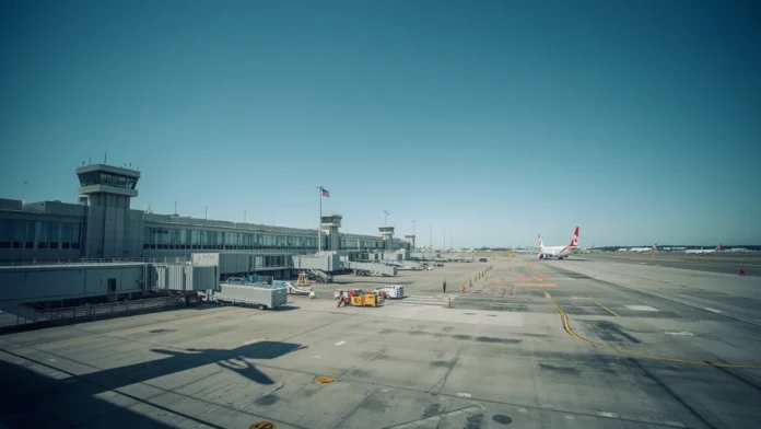 Toronto Pearson International Airport terminal with Canadian flag and commercial aircraft representing Transport Canada proposed air carrier security programme regulations published April 2026 with comment deadline June 24