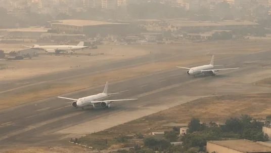 Busy commercial airport in South Asian urban environment with atmospheric haze, representing the dust deterioration environment driving CFM LEAP-1A HPT blade AD 2026-14-06`