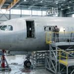 Large twin-engine widebody aircraft wing leading edge and nacelle on airport apron, representing FAA AD 2026-15-10 on wing sloping rib cracking inspections for Airbus A330neo operators