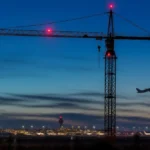 Crane with red obstacle warning lights near a UK airport, subject of the CAA CAP 1096 consultation
