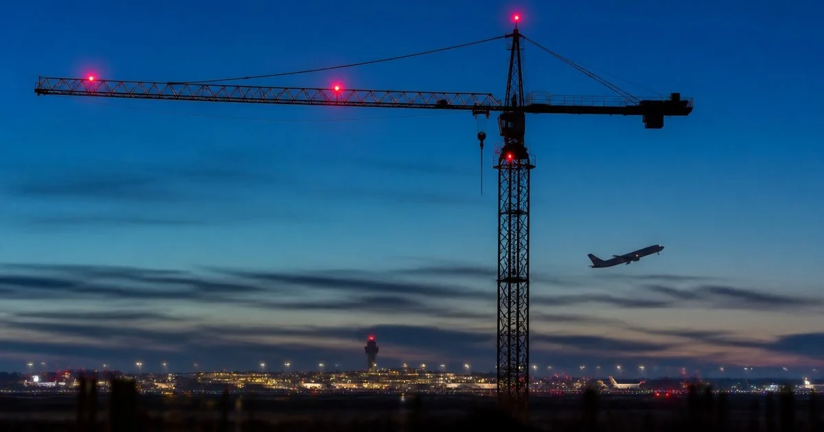 Crane with red obstacle warning lights near a UK airport, subject of the CAA CAP 1096 consultation